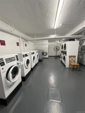 a utility room with multiple dryer and washer