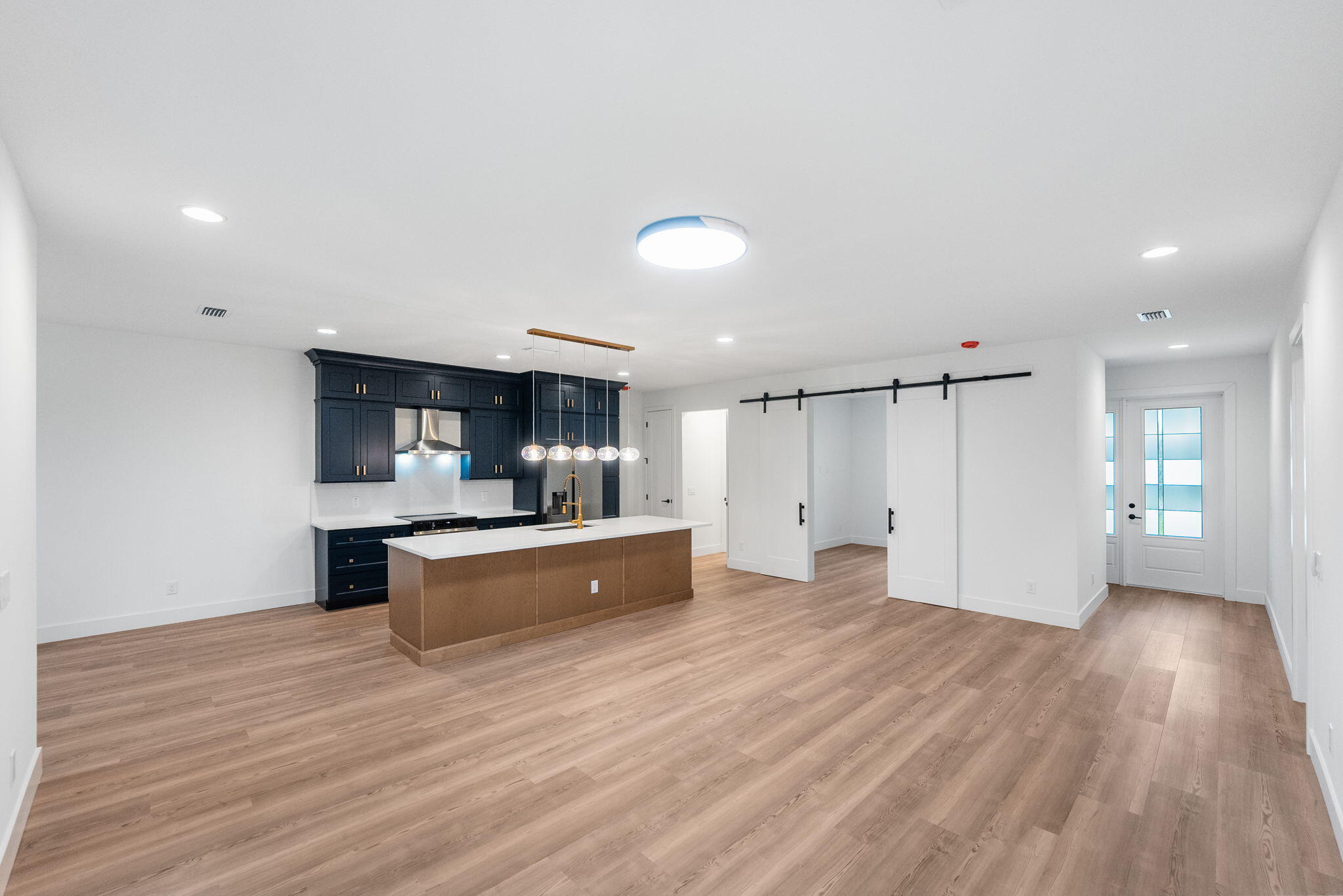 3113 Nighthawk Avenue Palm Bay, FL 32908 - Photo 14 of 33 a view of a kitchen with kitchen island a sink wooden floor and stainless steel appliances