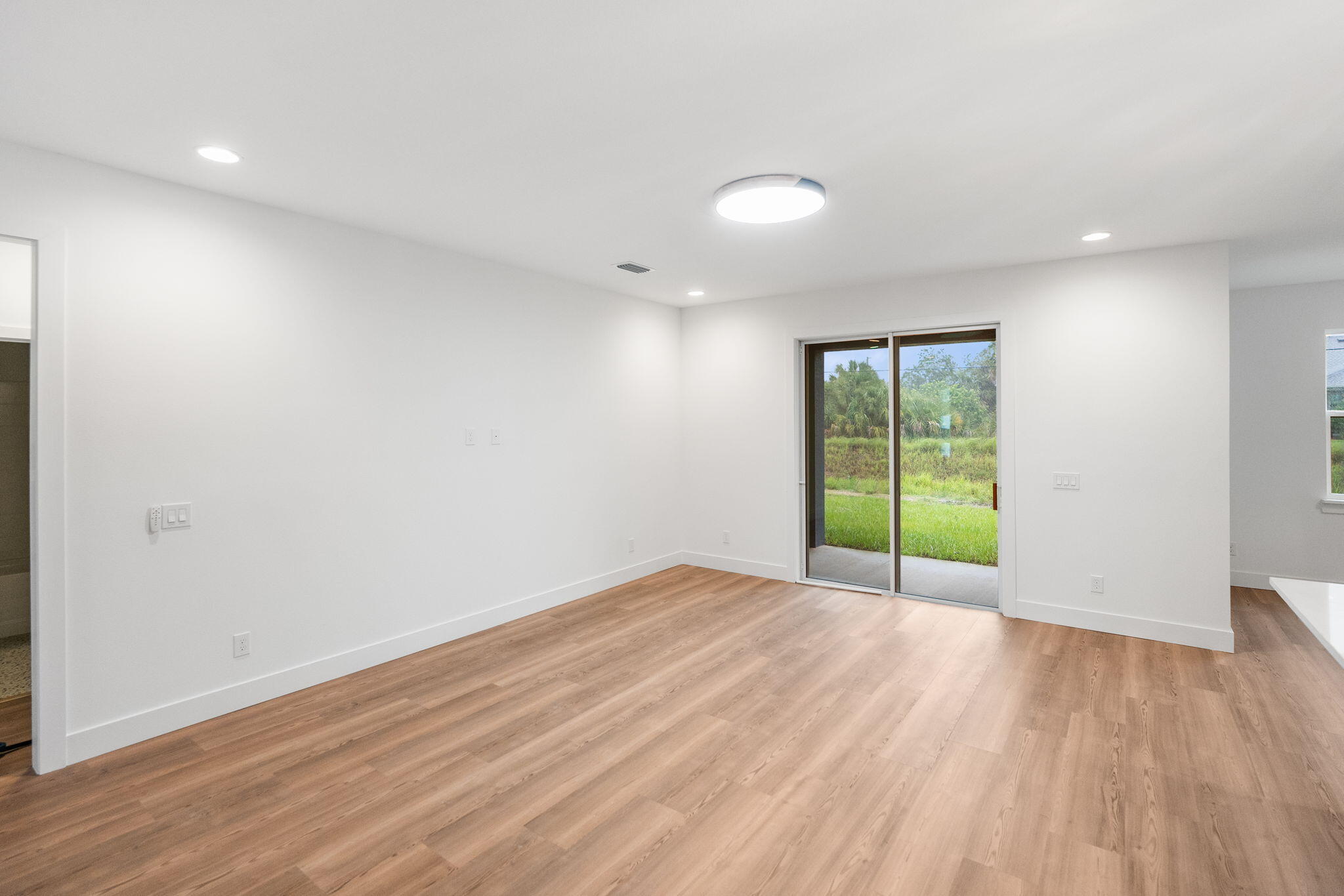 3113 Nighthawk Avenue Palm Bay, FL 32908 - Photo 16 of 33 wooden floor in an empty room with a window
