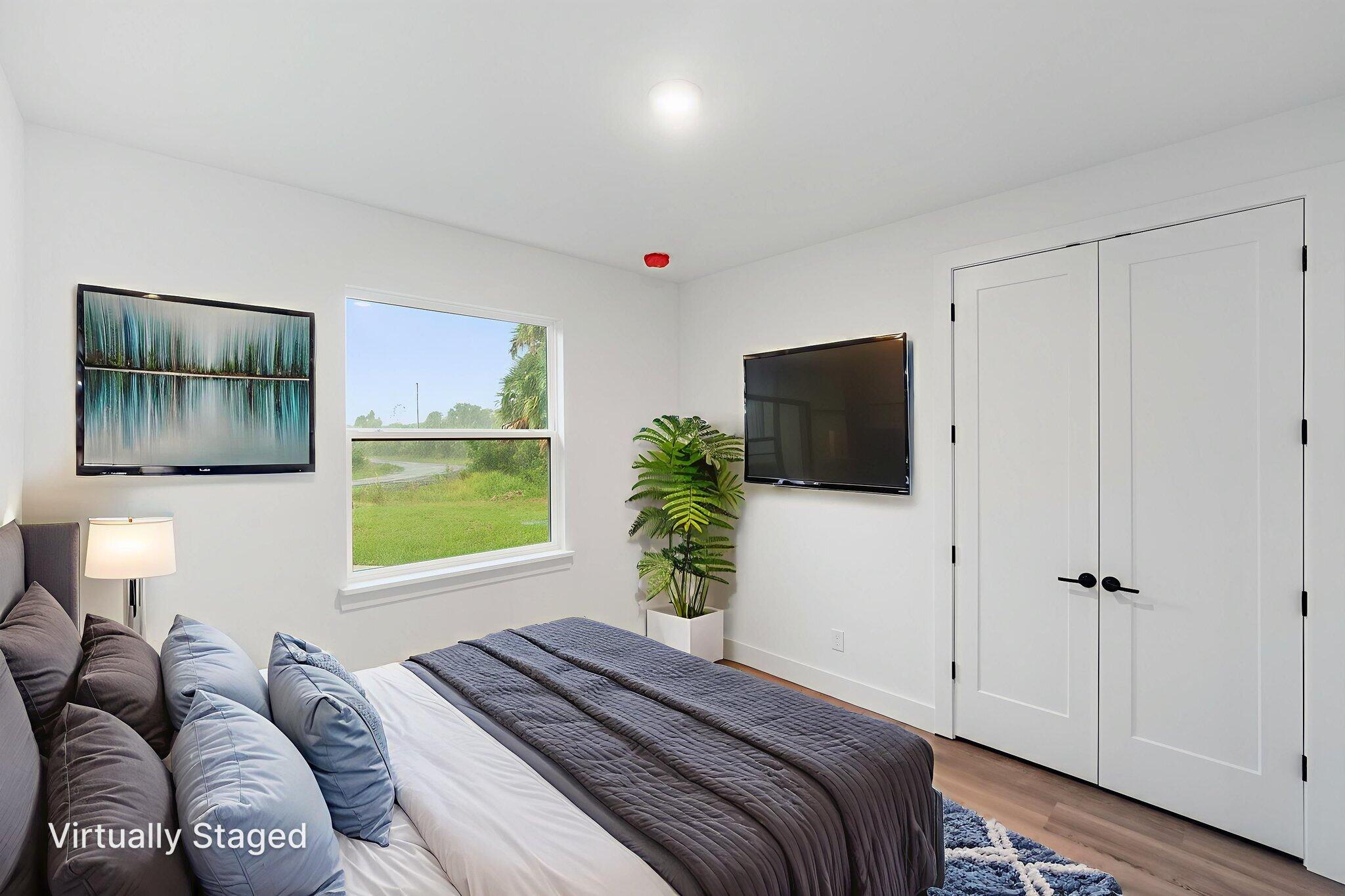 3113 Nighthawk Avenue Palm Bay, FL 32908 - Photo 22 of 33 a bedroom with a large bed and a flat screen tv