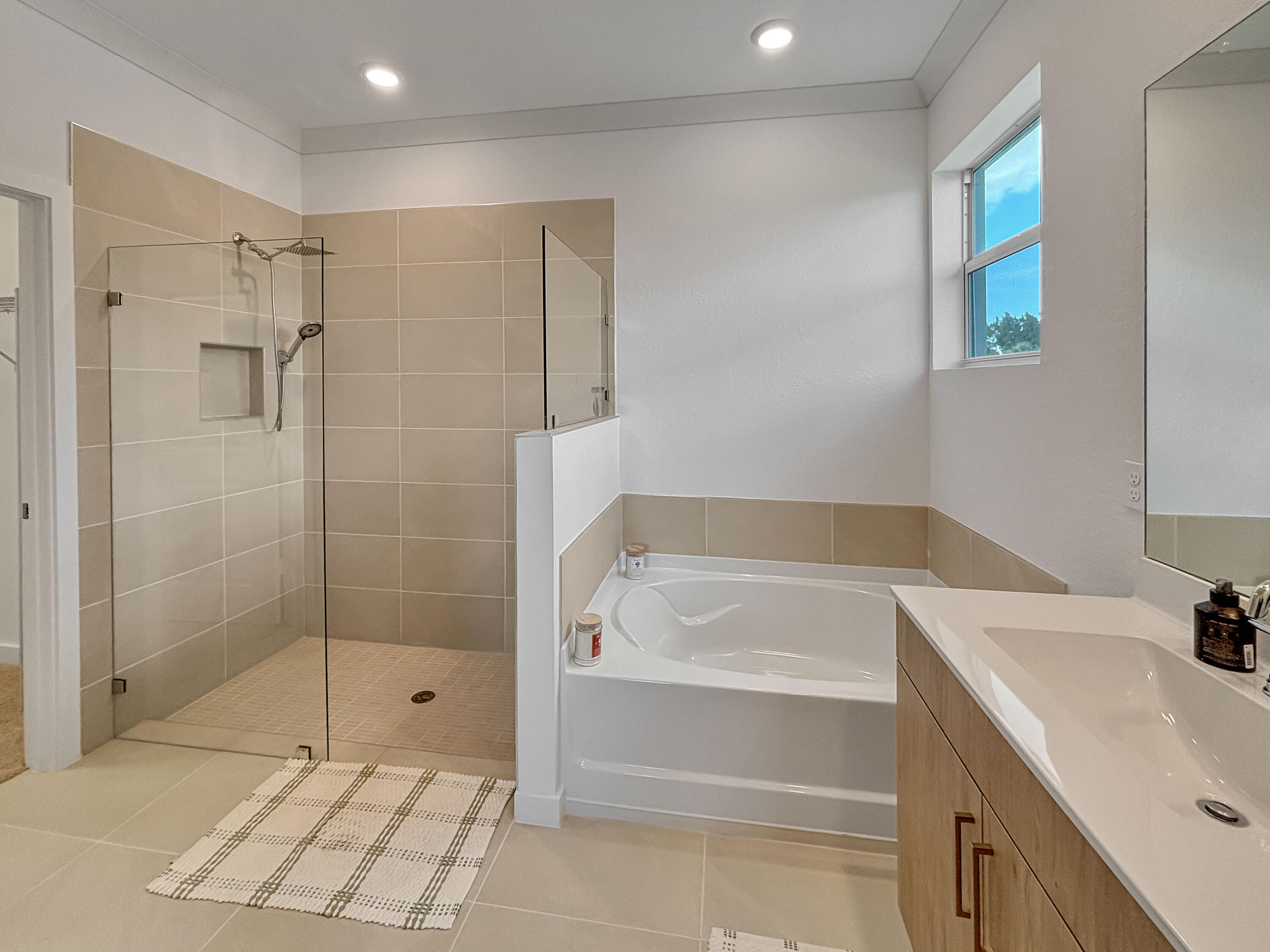 5989 Southeast Skyblue Circle Stuart, FL 34997 - Photo 21 of 37 a bathroom with a bathtub and a shower