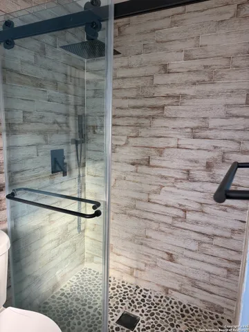 a bathroom with a black white checkered floor
