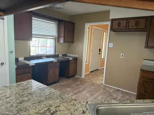 a view of a kitchen counter space and windows