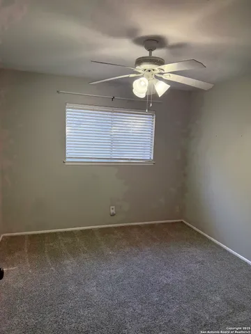 an empty room with an entrance and mirror