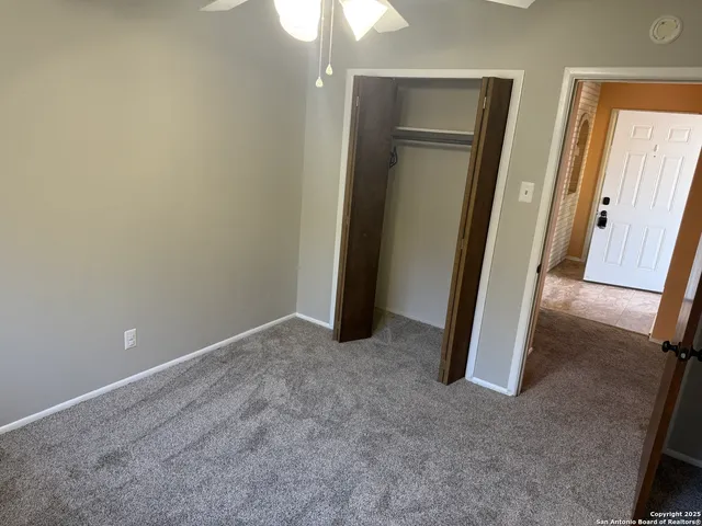 a bathroom with a granite countertop bathtub shower sink vanity and toilet