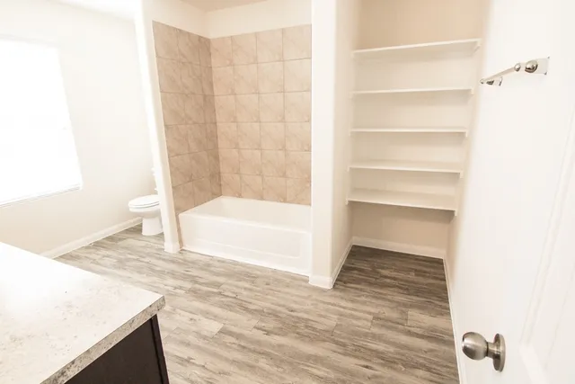 a bathroom with a bathtub and shower