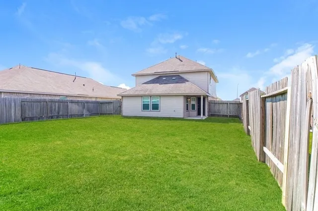 a view of a house with a back yard