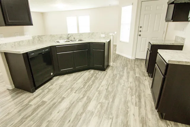 a kitchen with a sink stove and cabinets