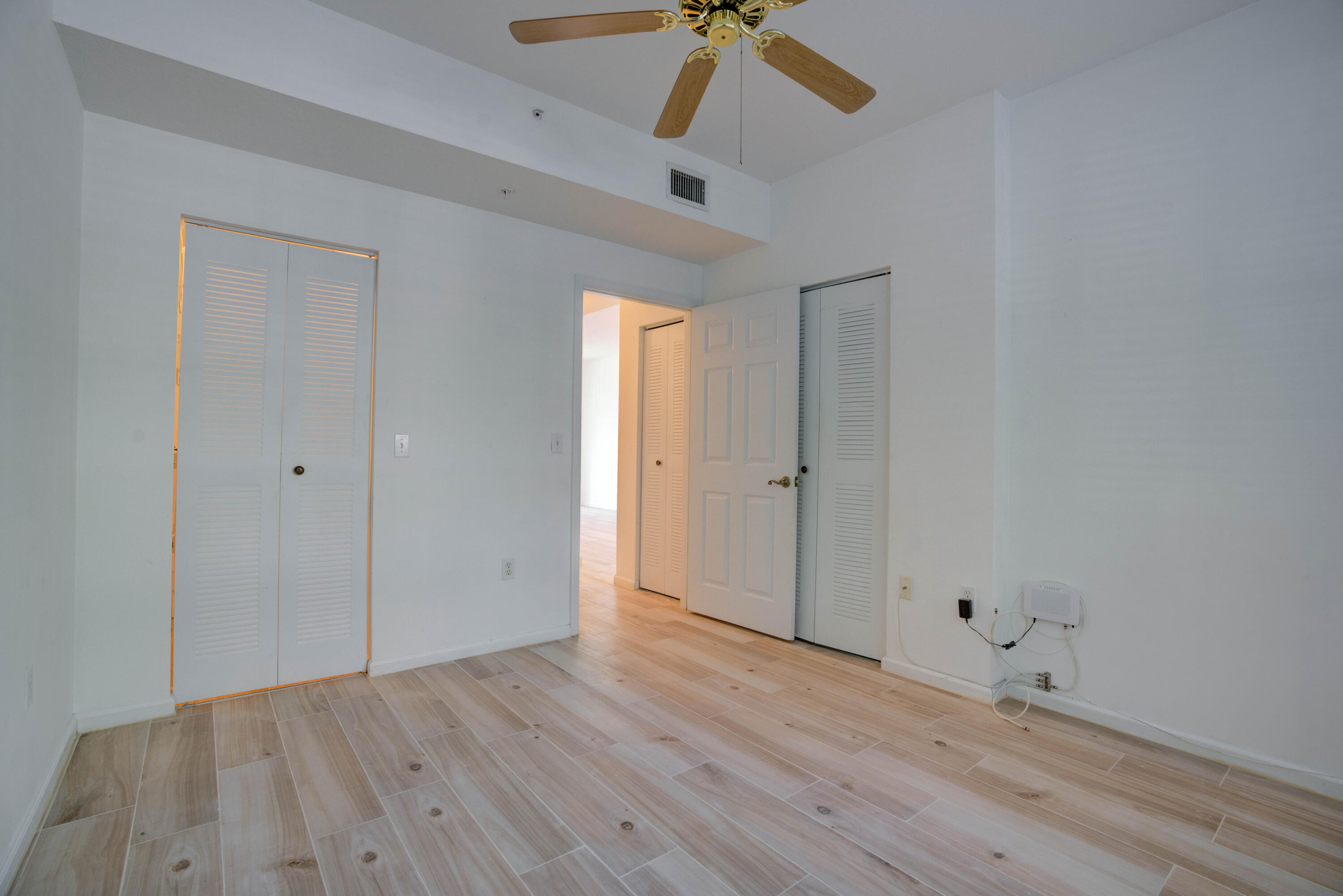 1136 Town Center Drive, Unit 11 Jupiter, FL 33458 - Photo 11 of 24 wooden floor in an empty room