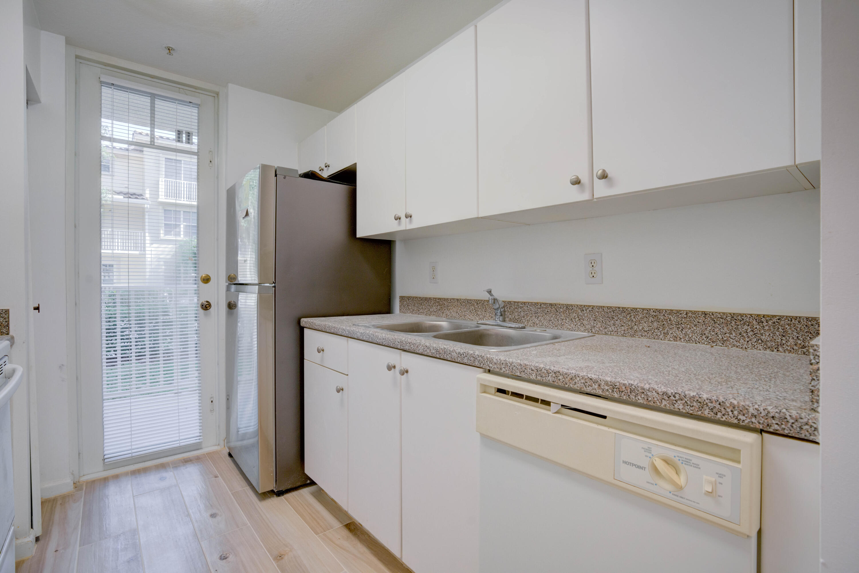1136 Town Center Drive, Unit 11 Jupiter, FL 33458 - Photo 15 of 24 a kitchen with a sink cabinets and wooden floor