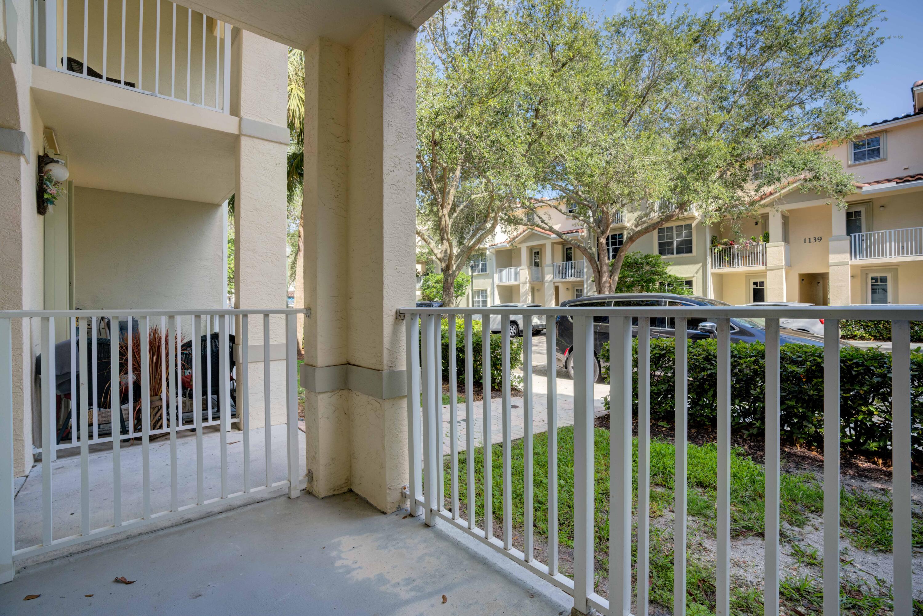 1136 Town Center Drive, Unit 11 Jupiter, FL 33458 - Photo 16 of 24 a view of a house with a small yard