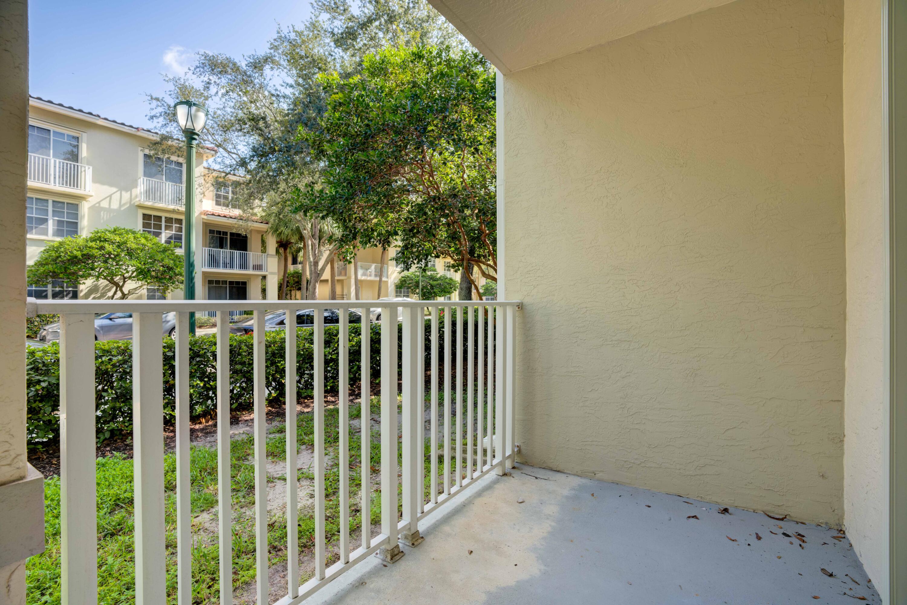 1136 Town Center Drive, Unit 11 Jupiter, FL 33458 - Photo 19 of 24 a view of a house with a small yard
