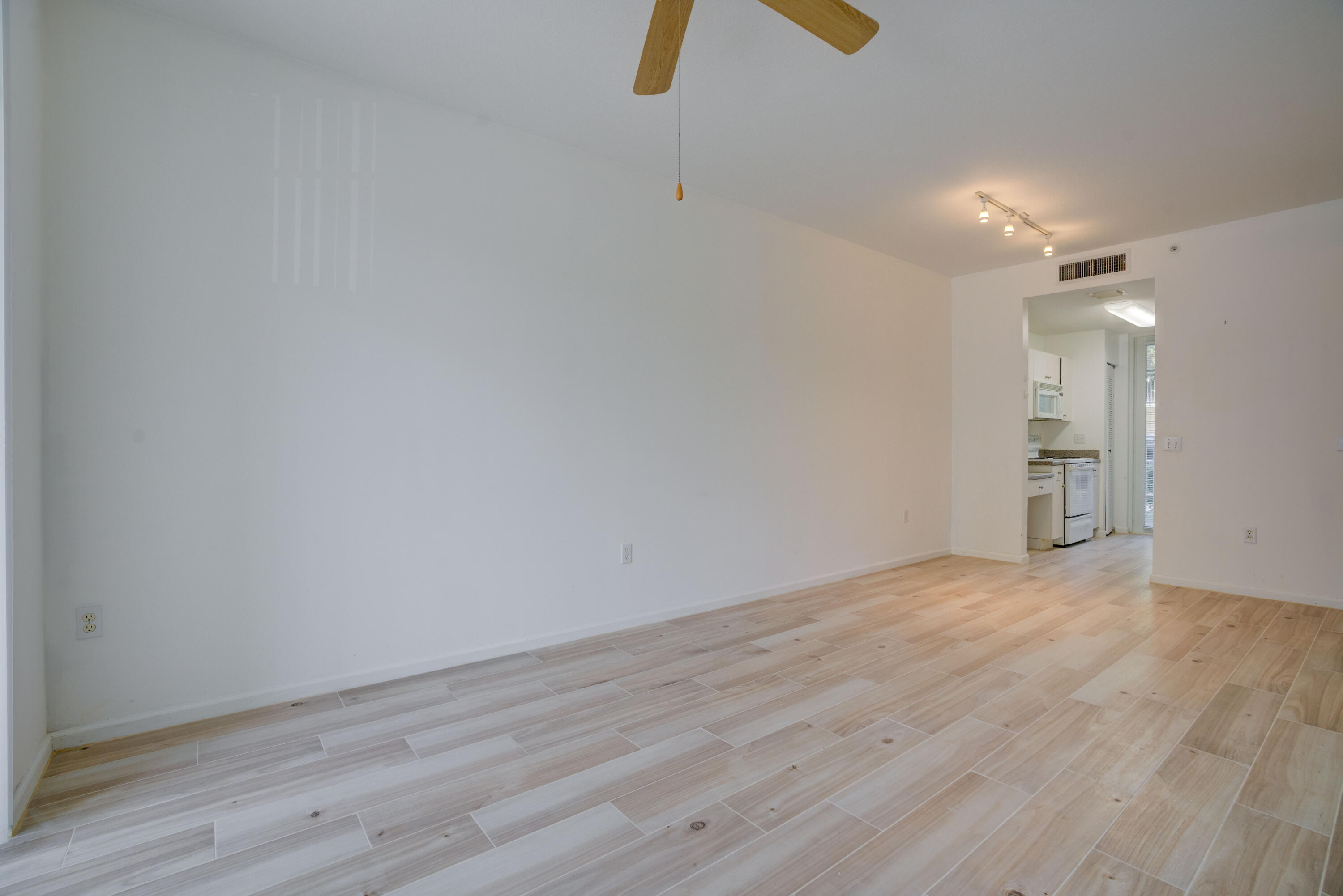 1136 Town Center Drive, Unit 11 Jupiter, FL 33458 - Photo 6 of 24 a view of empty room with wooden floor