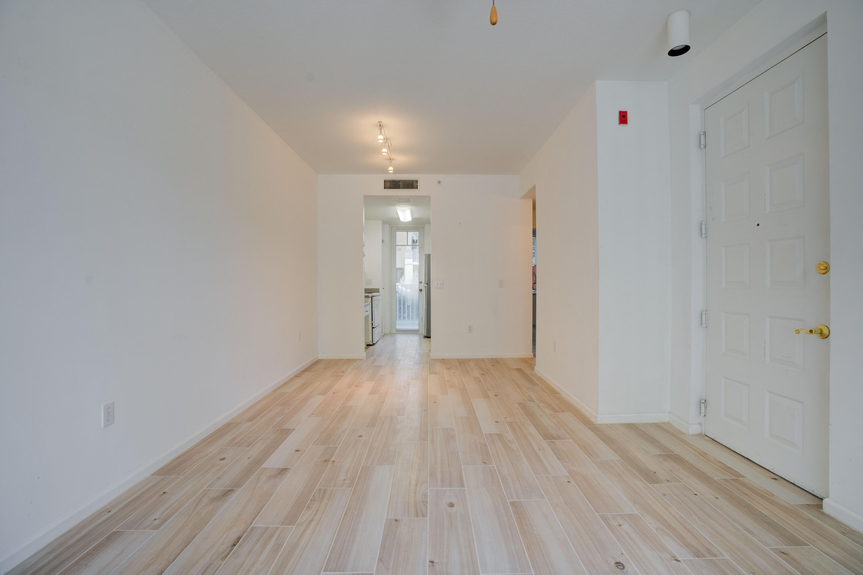 1136 Town Center Drive, Unit 11 Jupiter, FL 33458 - Photo 7 of 24 a view of wooden floor and windows in a room