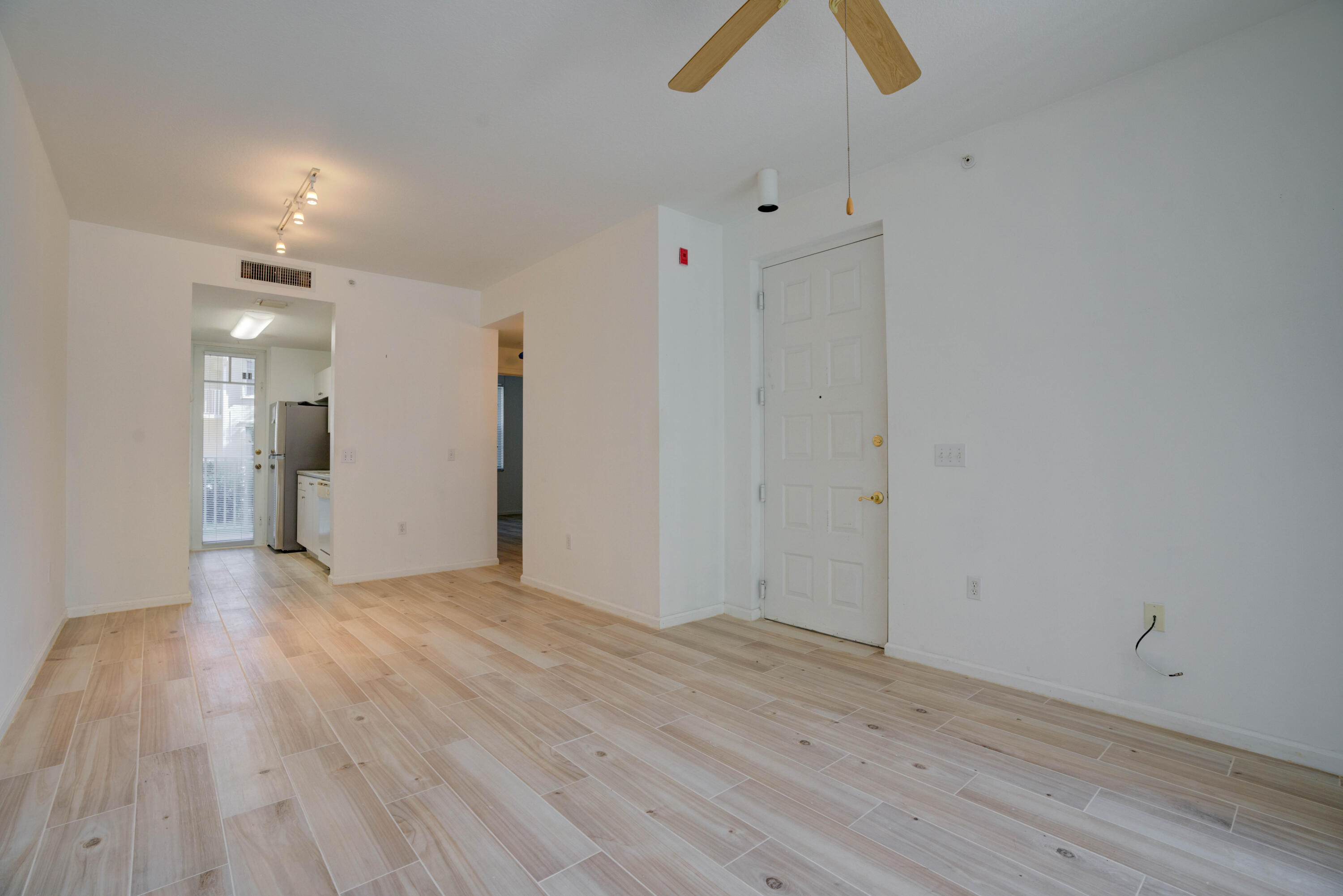 1136 Town Center Drive, Unit 11 Jupiter, FL 33458 - Photo 8 of 24 a view of empty room with wooden floor