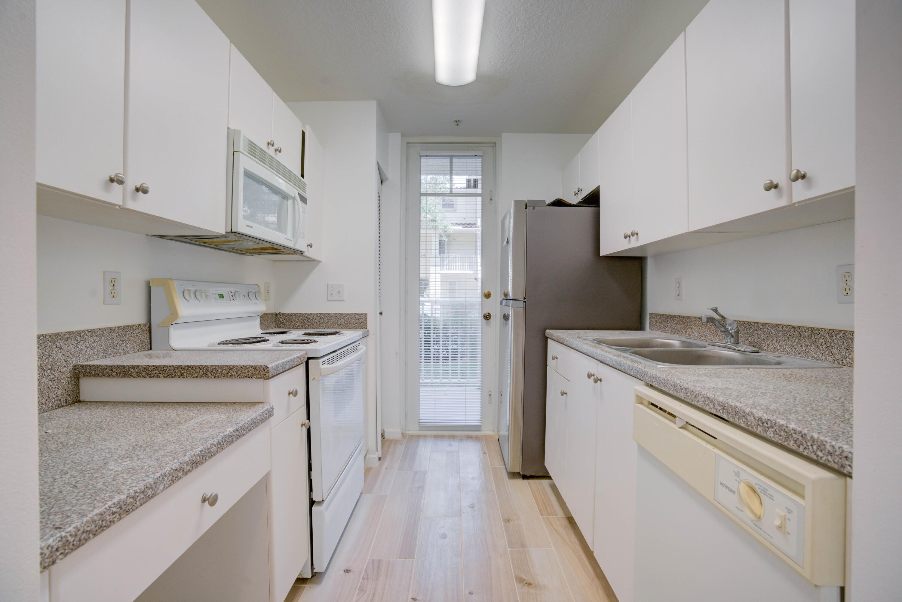 1136 Town Center Drive, Unit 11 Jupiter, FL 33458 - Photo 10 of 24 a kitchen with stainless steel appliances granite countertop a stove and a sink