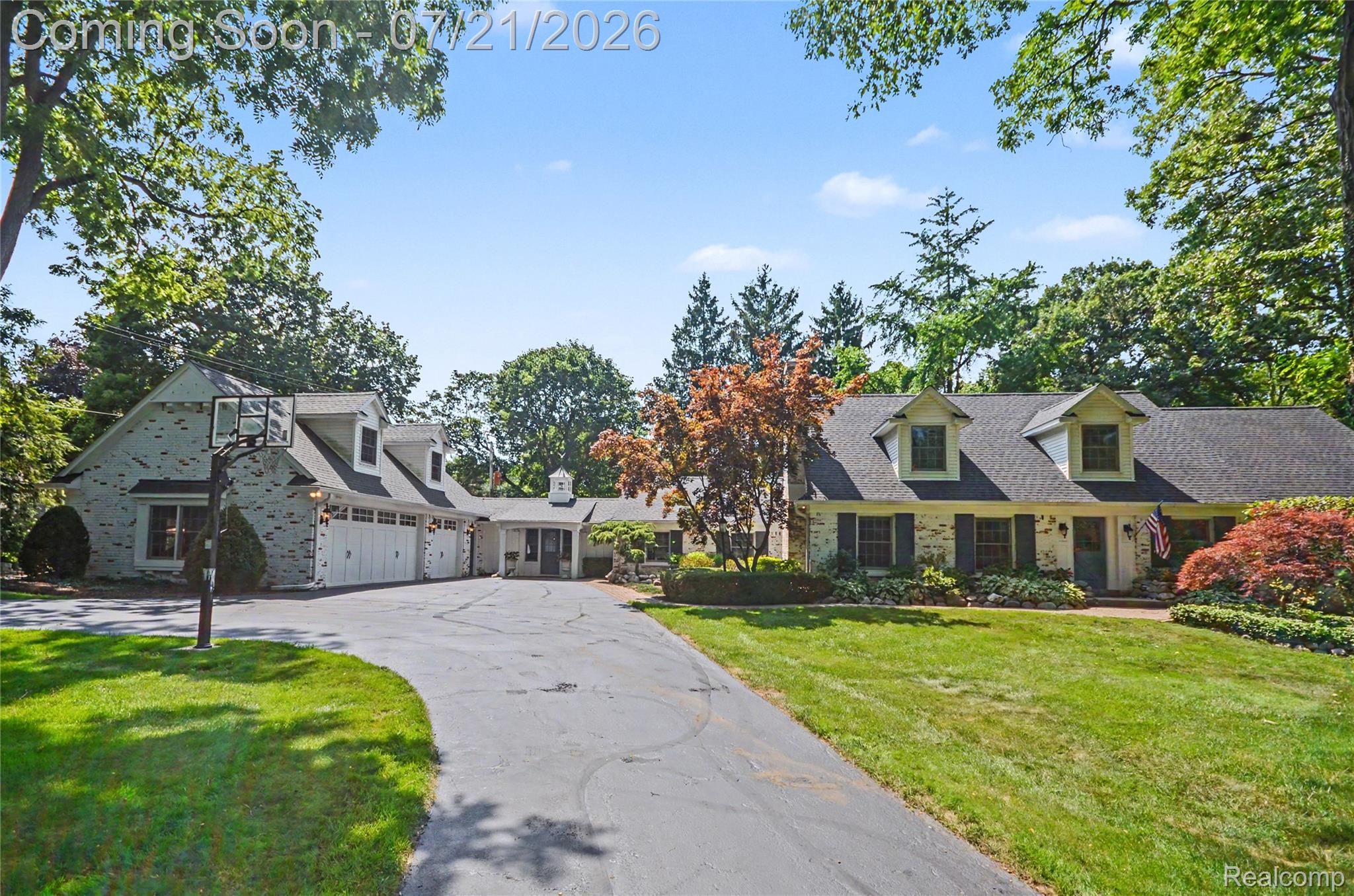 3780 Squirrel Road Bloomfield Hills, MI 48304 - Photo 4 of 59 Expansive front exterior with a long asphalt driveway, mature trees, and manicured landscaping