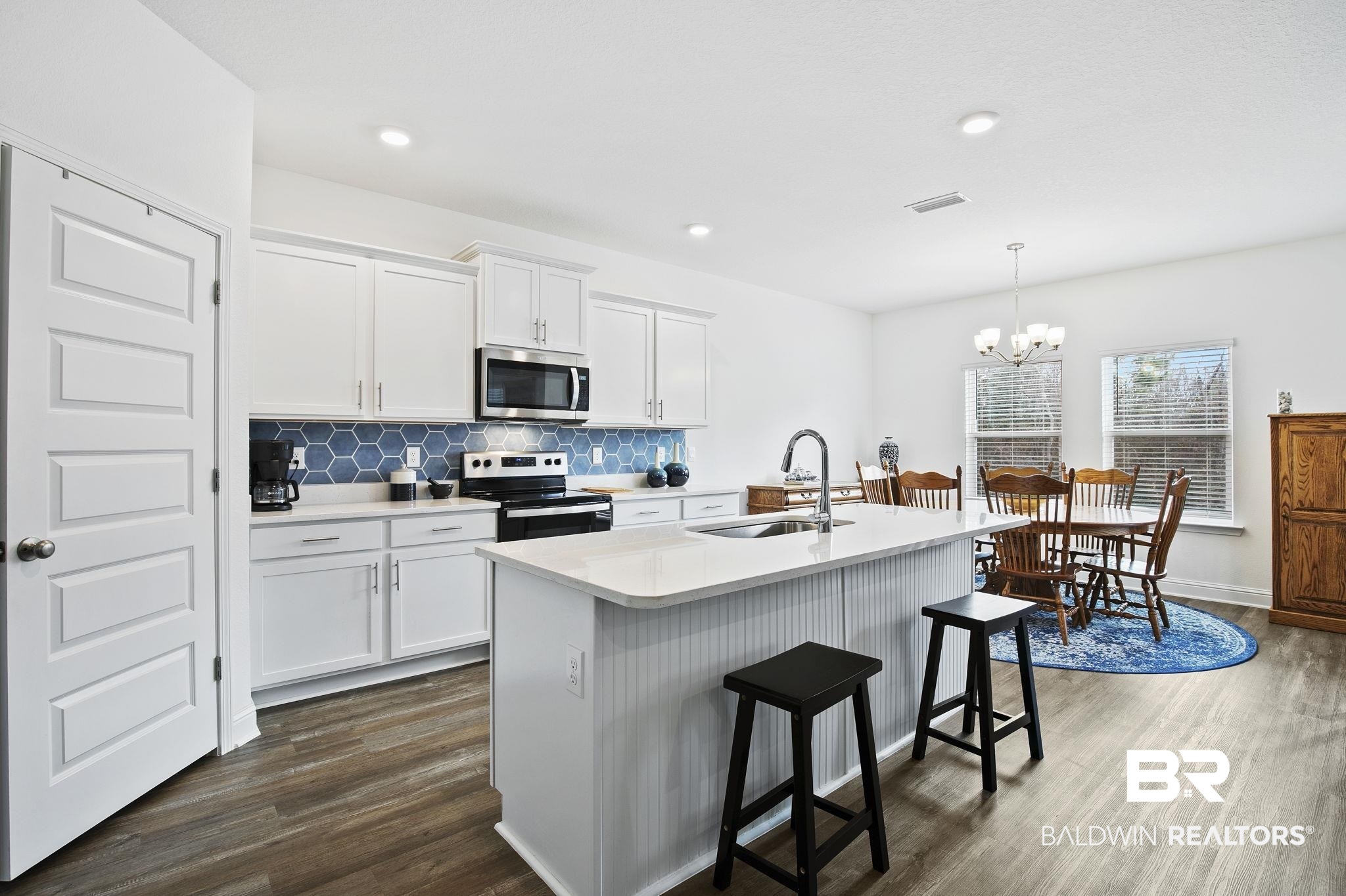 1141 Pencarro Boulevard Foley, AL 36535 - Photo 15 of 70 Kitchen featuring white cabinetry, sink, pendant lighting, and stainless steel appliances