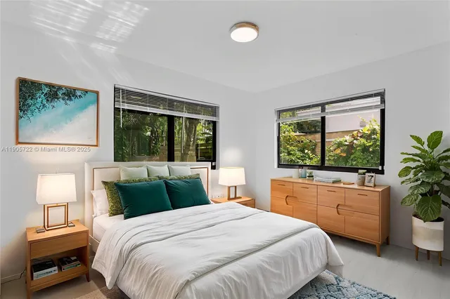 a bedroom with a large bed and a window