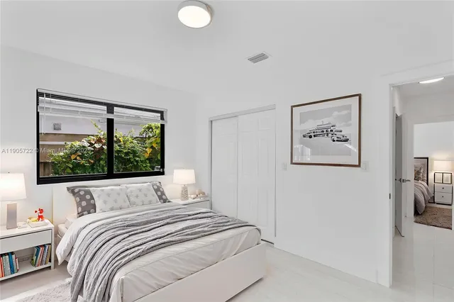 a bedroom with a large bed and a window