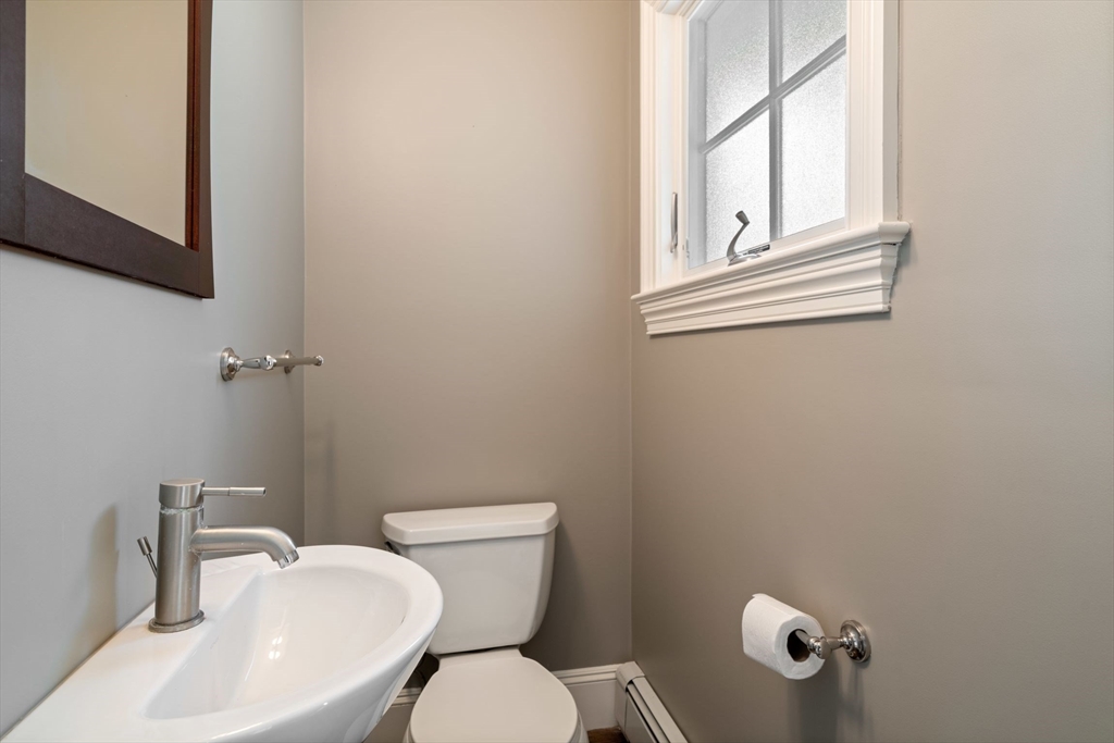 23 Bellis Circle Cambridge, MA 02140 - Photo 11 of 24 a white toilet sitting next to a bathroom sink