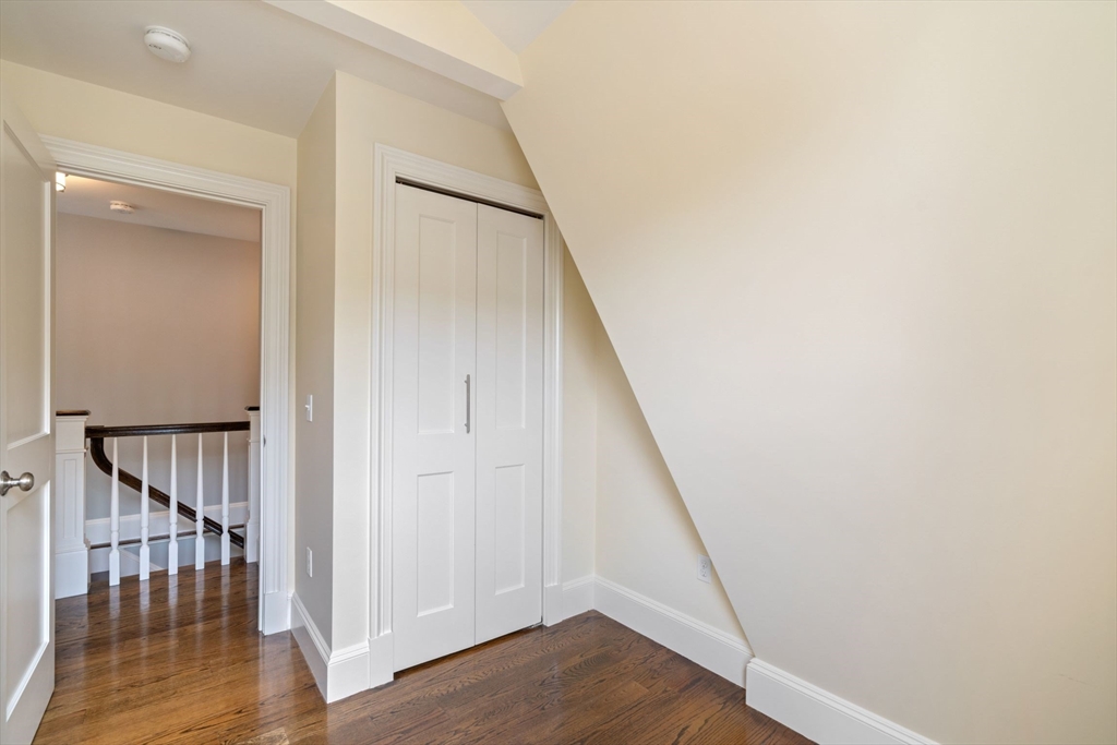 23 Bellis Circle Cambridge, MA 02140 - Photo 12 of 24 a view of a hallway with wooden floor and staircase