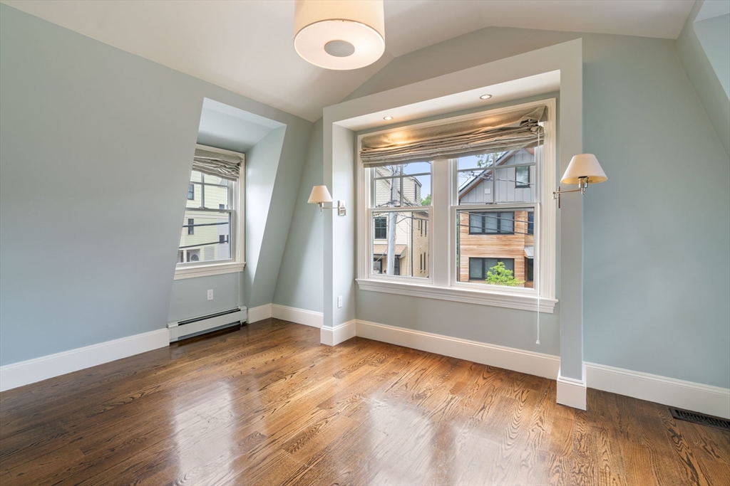 23 Bellis Circle Cambridge, MA 02140 - Photo 16 of 24 an empty room with wooden floor and windows