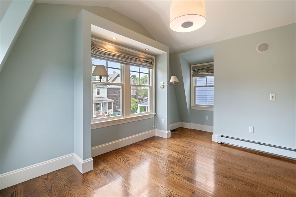 23 Bellis Circle Cambridge, MA 02140 - Photo 17 of 24 an empty room with wooden floor and windows