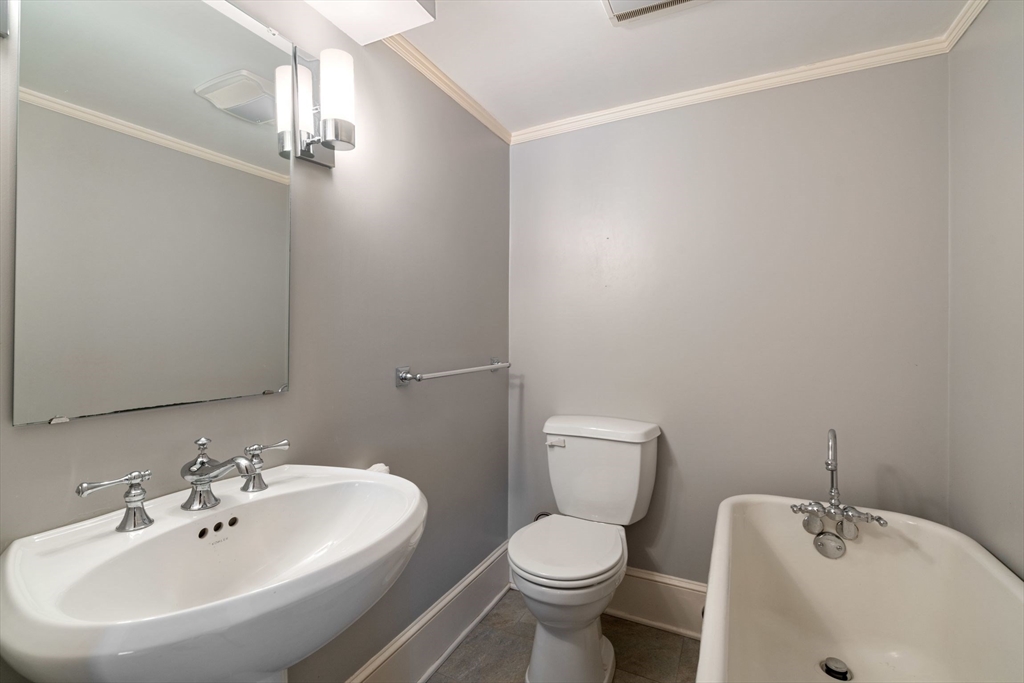 23 Bellis Circle Cambridge, MA 02140 - Photo 18 of 24 a bathroom with a toilet a sink and mirror