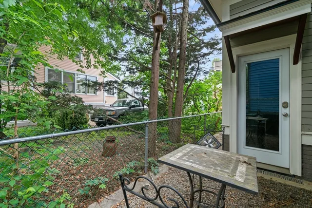 a view of a patio with table and chairs and potted plants