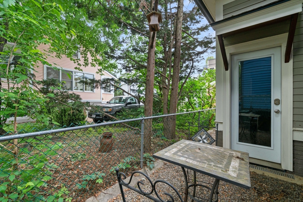 23 Bellis Circle Cambridge, MA 02140 - Photo 21 of 24 a view of a patio with table and chairs and potted plants