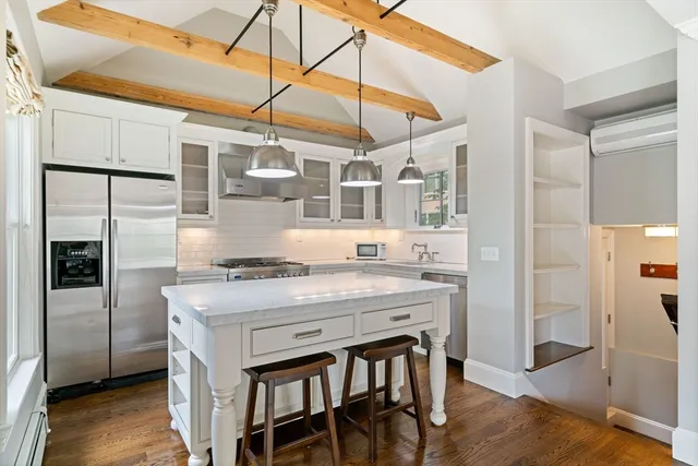 a kitchen with a stove a refrigerator and cabinets
