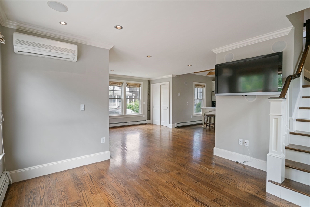 23 Bellis Circle Cambridge, MA 02140 - Photo 10 of 24 a view of a livingroom with wooden floor and a flat screen tv