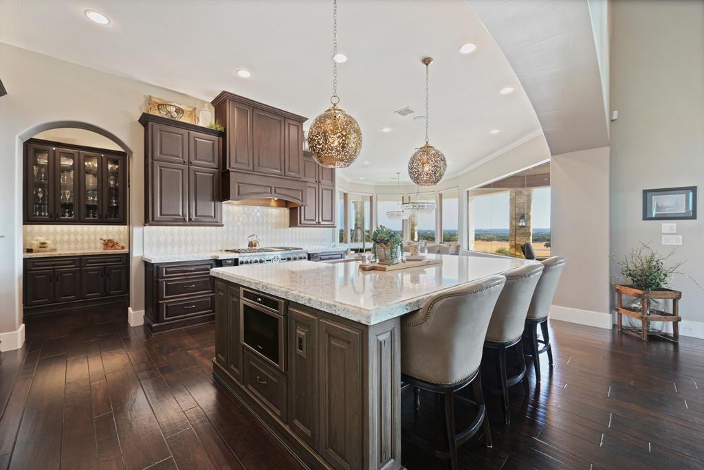 325 River Ridge Spring Branch, TX 78070 - Photo 16 of 40 a kitchen with stainless steel appliances granite countertop a stove a sink dishwasher and a refrigerator with wooden floor
