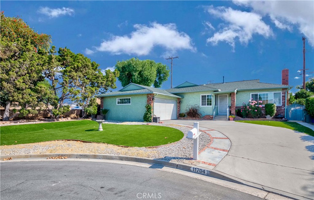 11704 Ronald Drive La Mirada, CA 90638 - Photo 1 of 1 a front view of a house with a yard and garage