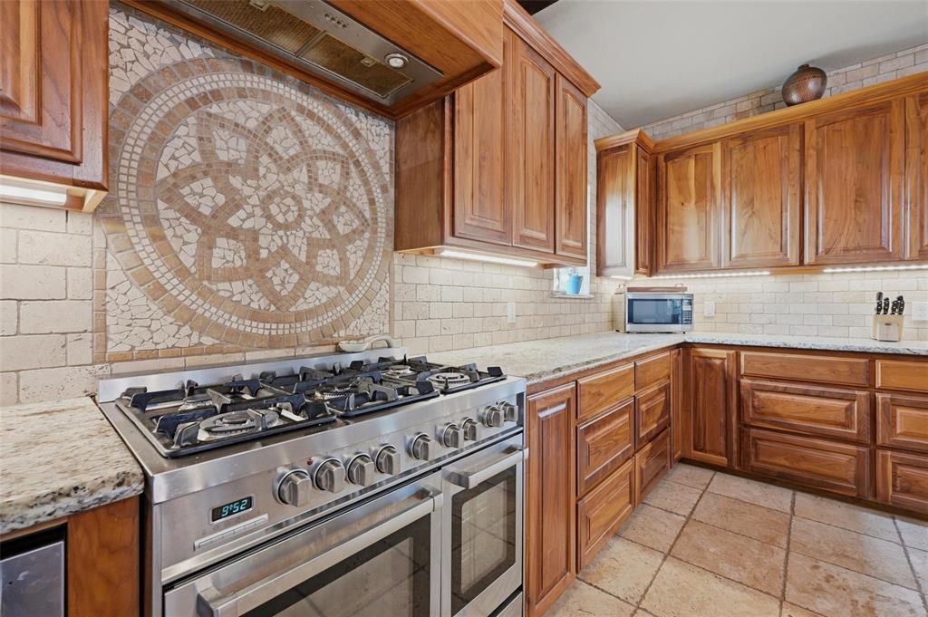 1959 Marlow Road Bells, TX 75414 - Photo 12 of 33 a kitchen with stainless steel appliances granite countertop a stove and a sink