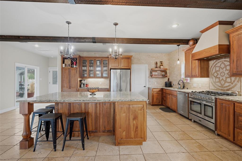 1959 Marlow Road Bells, TX 75414 - Photo 12 of 32 a kitchen with cabinets and chairs