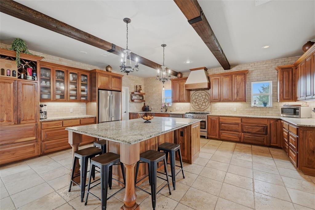1959 Marlow Road Bells, TX 75414 - Photo 13 of 32 a kitchen with stainless steel appliances granite countertop a sink and a refrigerator