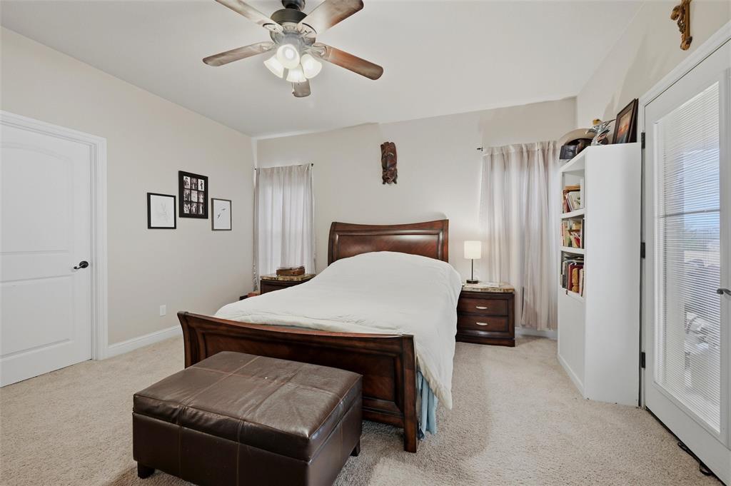 1959 Marlow Road Bells, TX 75414 - Photo 16 of 32 a bedroom with a bed and a chandelier