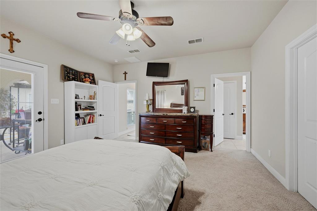 1959 Marlow Road Bells, TX 75414 - Photo 18 of 32 a bedroom with a bed and a chandelier