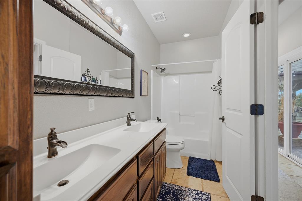 1959 Marlow Road Bells, TX 75414 - Photo 25 of 32 a bathroom with a sink and a mirror
