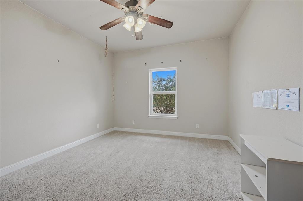 1959 Marlow Road Bells, TX 75414 - Photo 26 of 32 an empty room with windows and fan