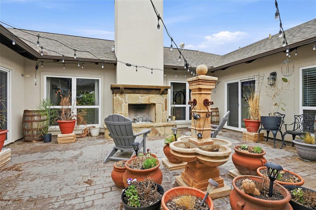 1959 Marlow Road Bells, TX 75414 - Photo 29 of 32 a dining room with furniture a fireplace and wooden floor