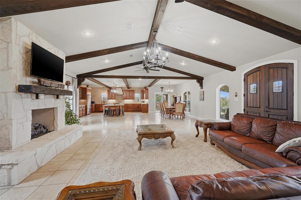 1959 Marlow Road Bells, TX 75414 - Photo 8 of 32 a living room with furniture a flat screen tv and a fireplace