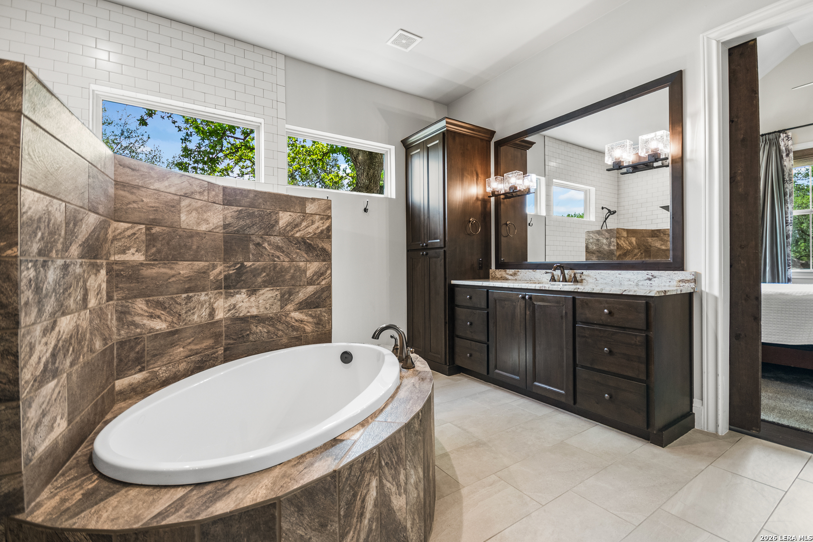 55 Brook Ridge Boerne, TX 78015 - Photo 30 of 59 a bathroom with a tub sink and mirror