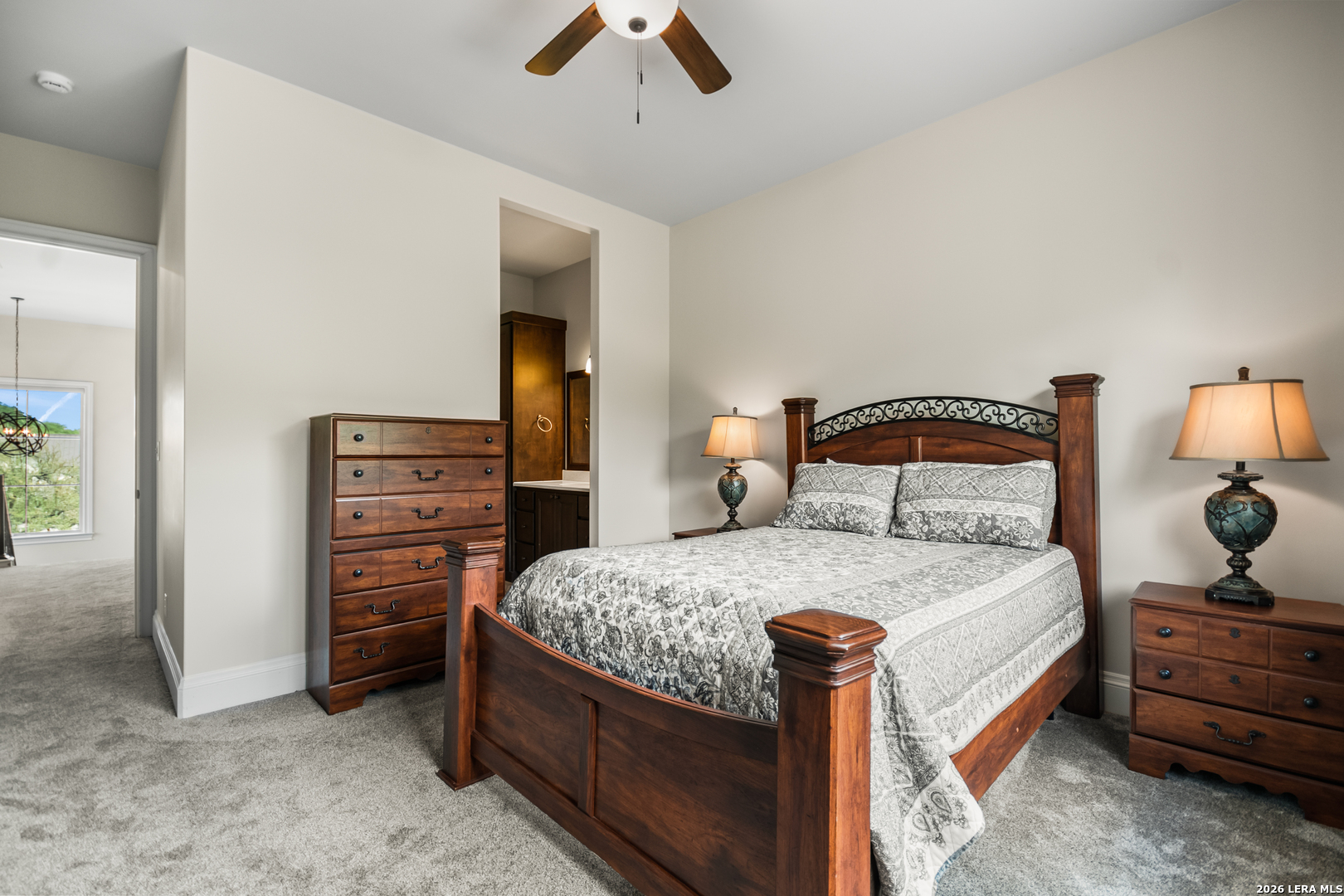 55 Brook Ridge Boerne, TX 78015 - Photo 36 of 59 a bedroom with a bed and a chandelier