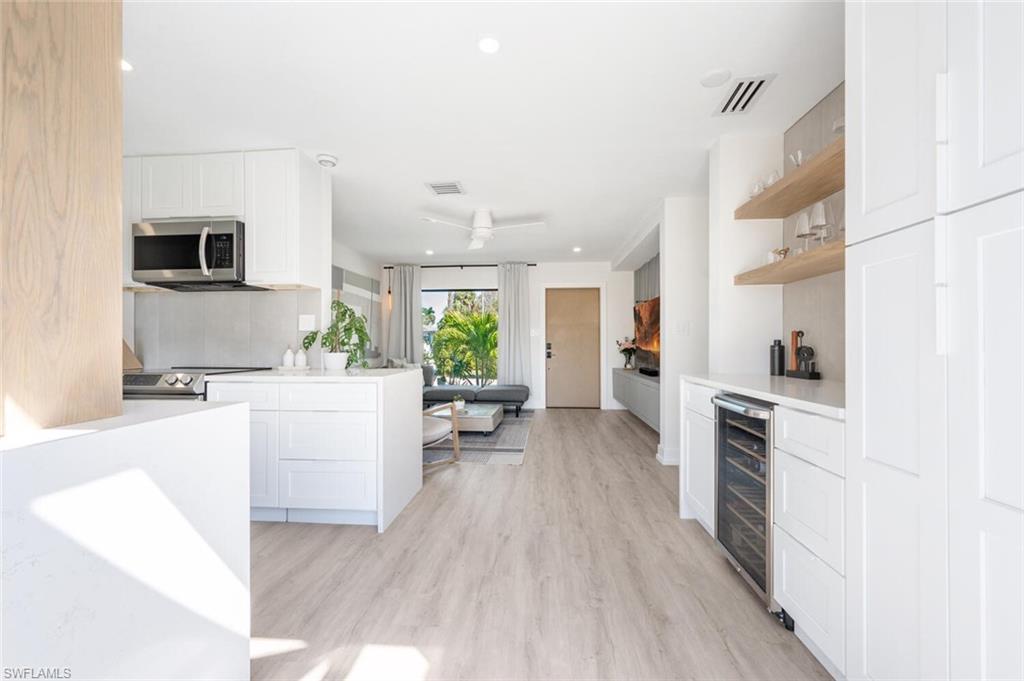 4608 Normandy Drive Naples, FL 34112 - Photo 16 of 49 a living room with furniture and a kitchen view