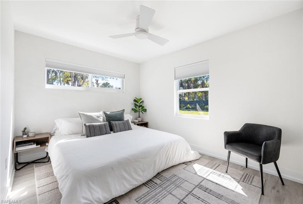 4608 Normandy Drive Naples, FL 34112 - Photo 17 of 49 a bedroom with a bed and a chair