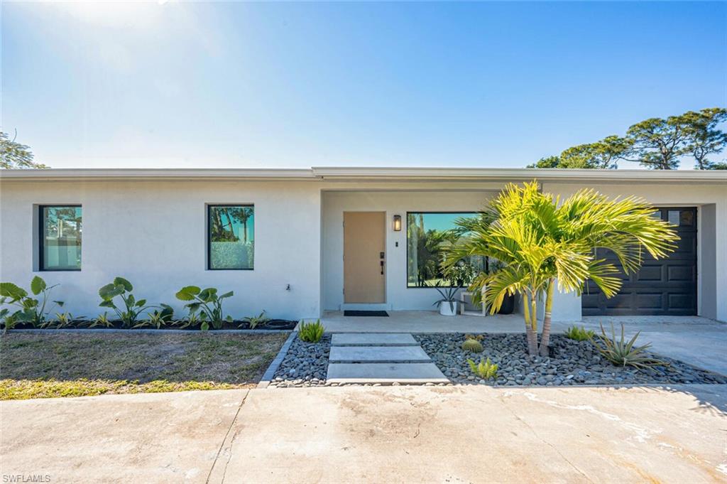 4608 Normandy Drive Naples, FL 34112 - Photo 2 of 49 a front view of a house with garden