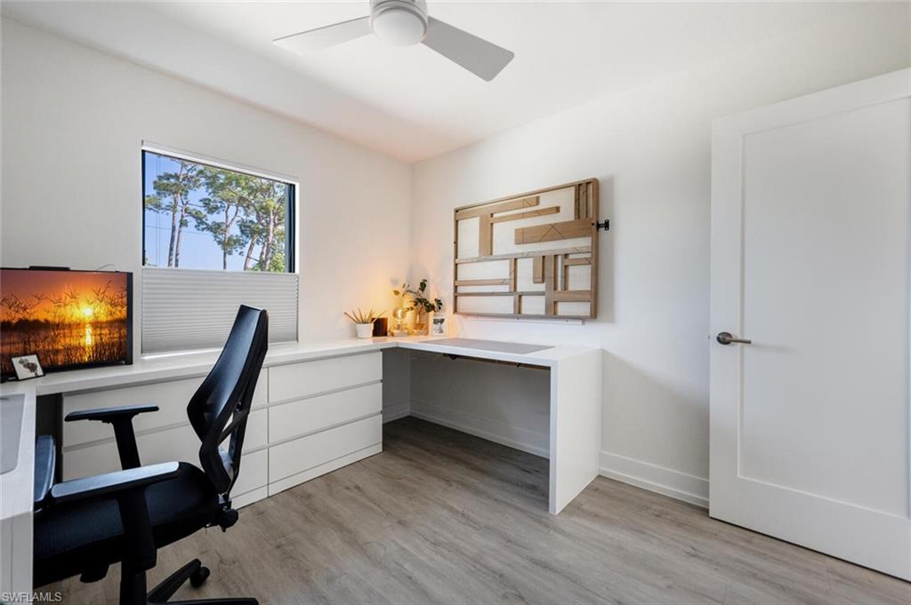 4608 Normandy Drive Naples, FL 34112 - Photo 21 of 49 a view of room with chair and wooden floor
